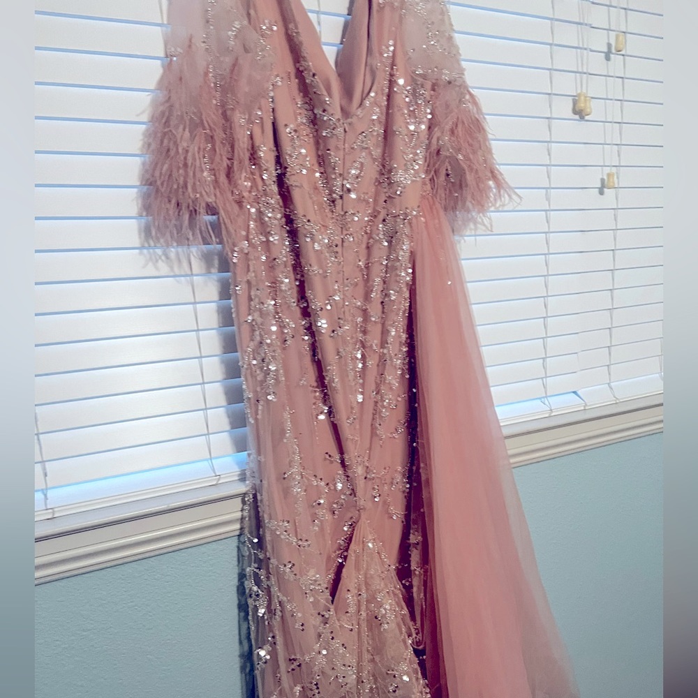 Couture dress. Stunning with tons of sequins and feathers. Worn once.